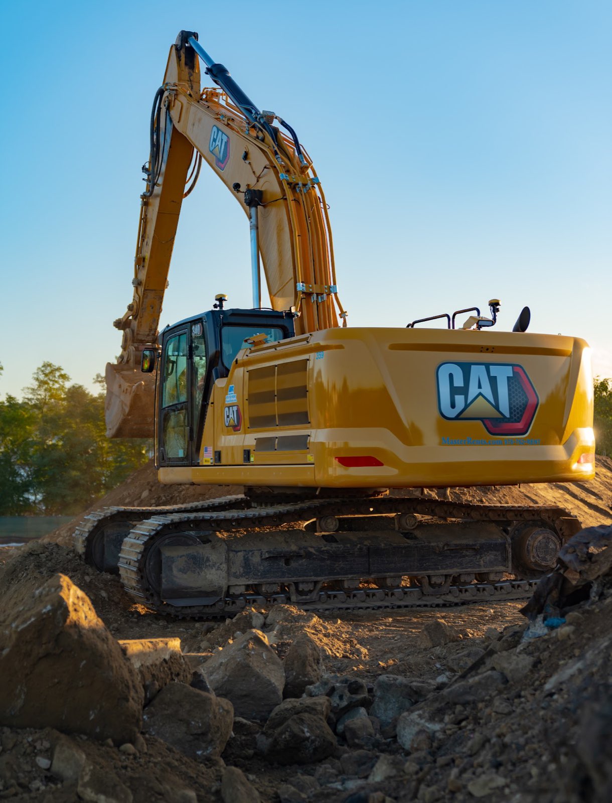 Side and rear view of a tracked excavator on rocky ground at the Waterhouse site.