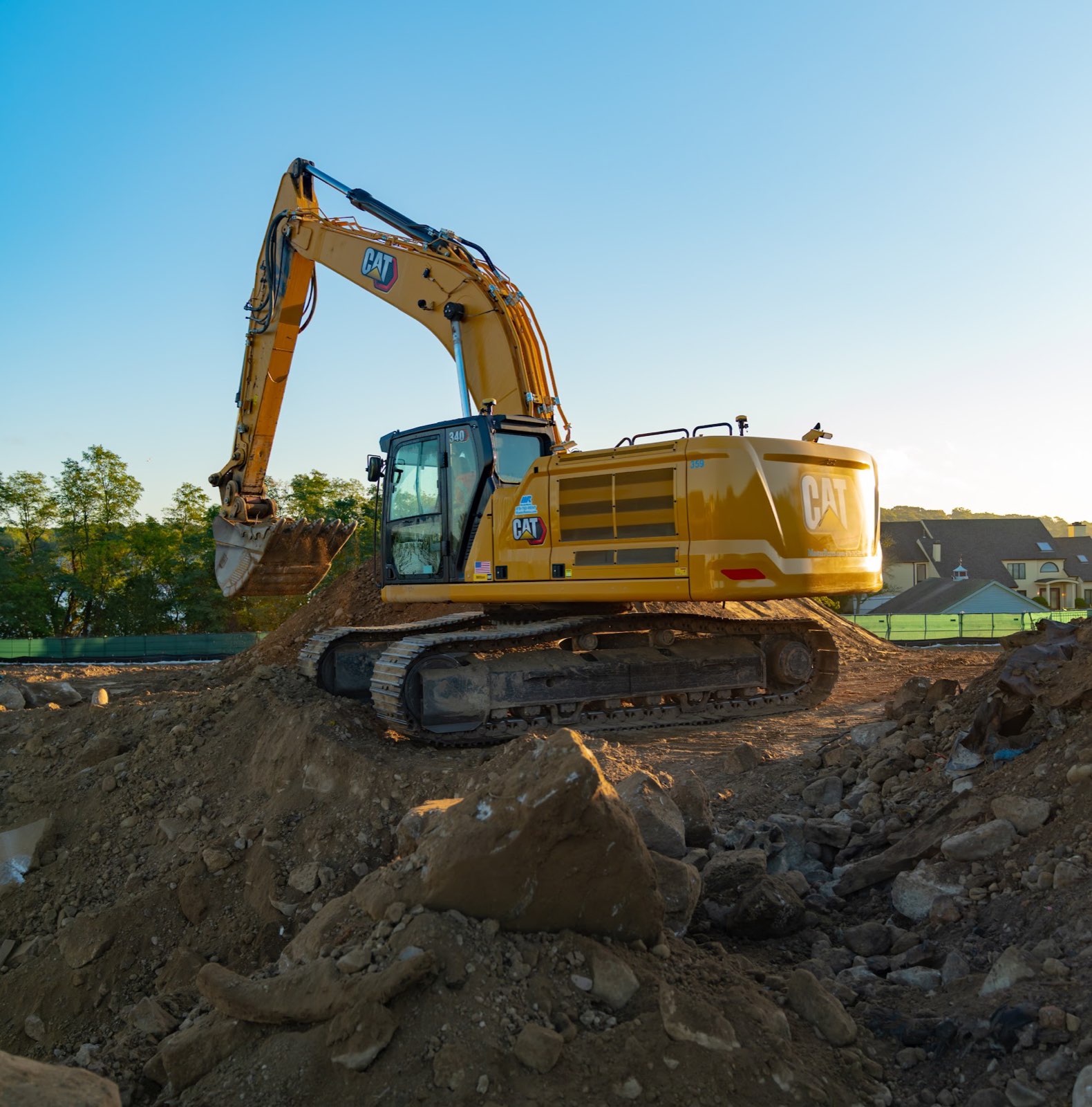 Excavator beside a soil stockpile at the Waterhouse redevelopment site.