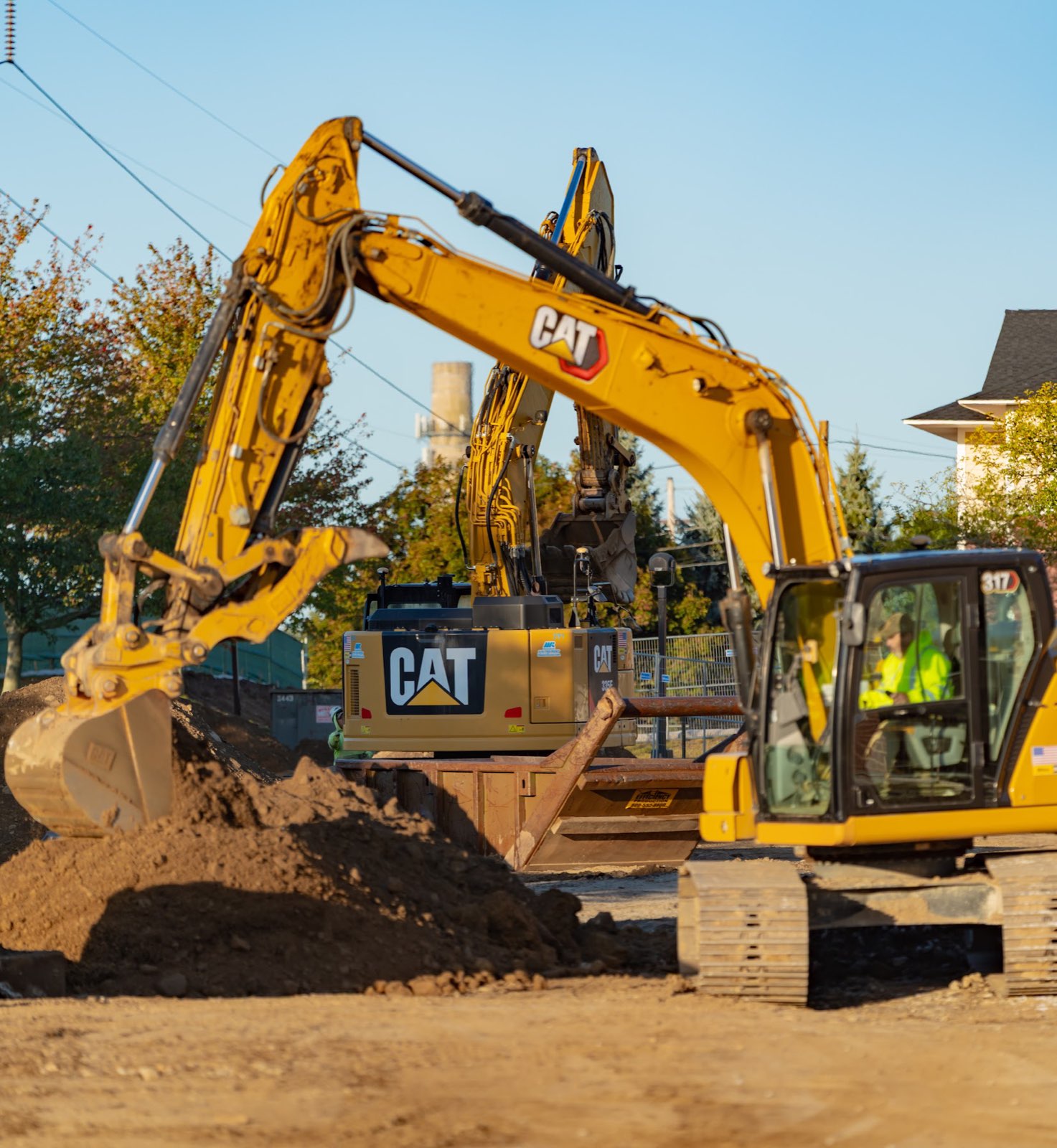 Several excavators working around soil piles at the Waterhouse redevelopment site.